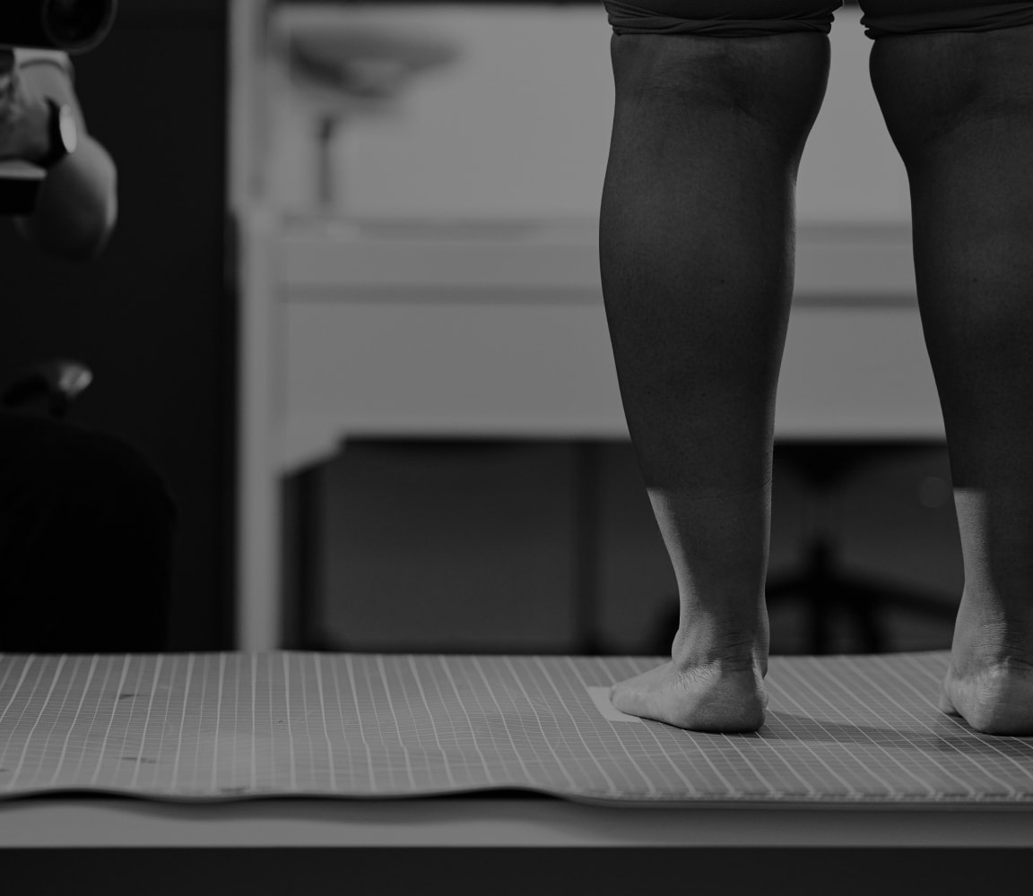model standing to have her calf and foot measured