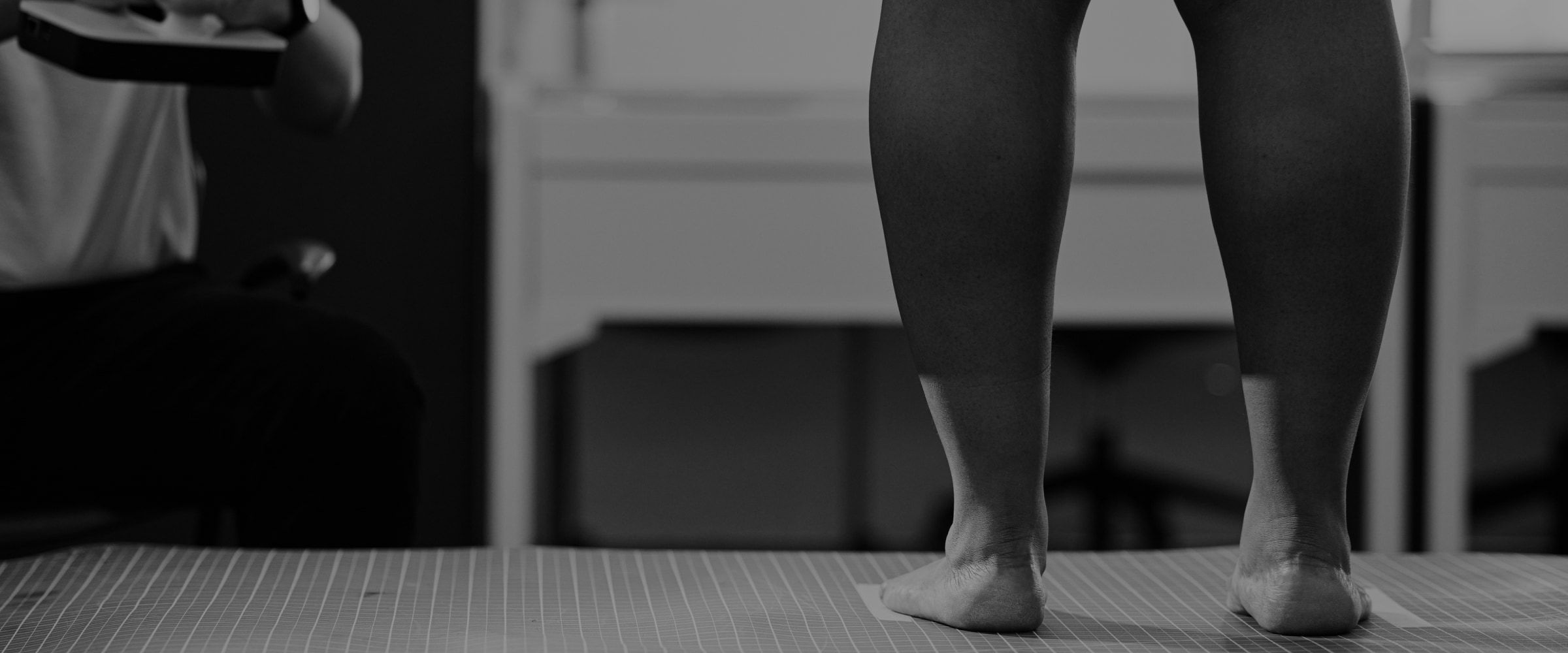 model standing to have her calf and foot measured